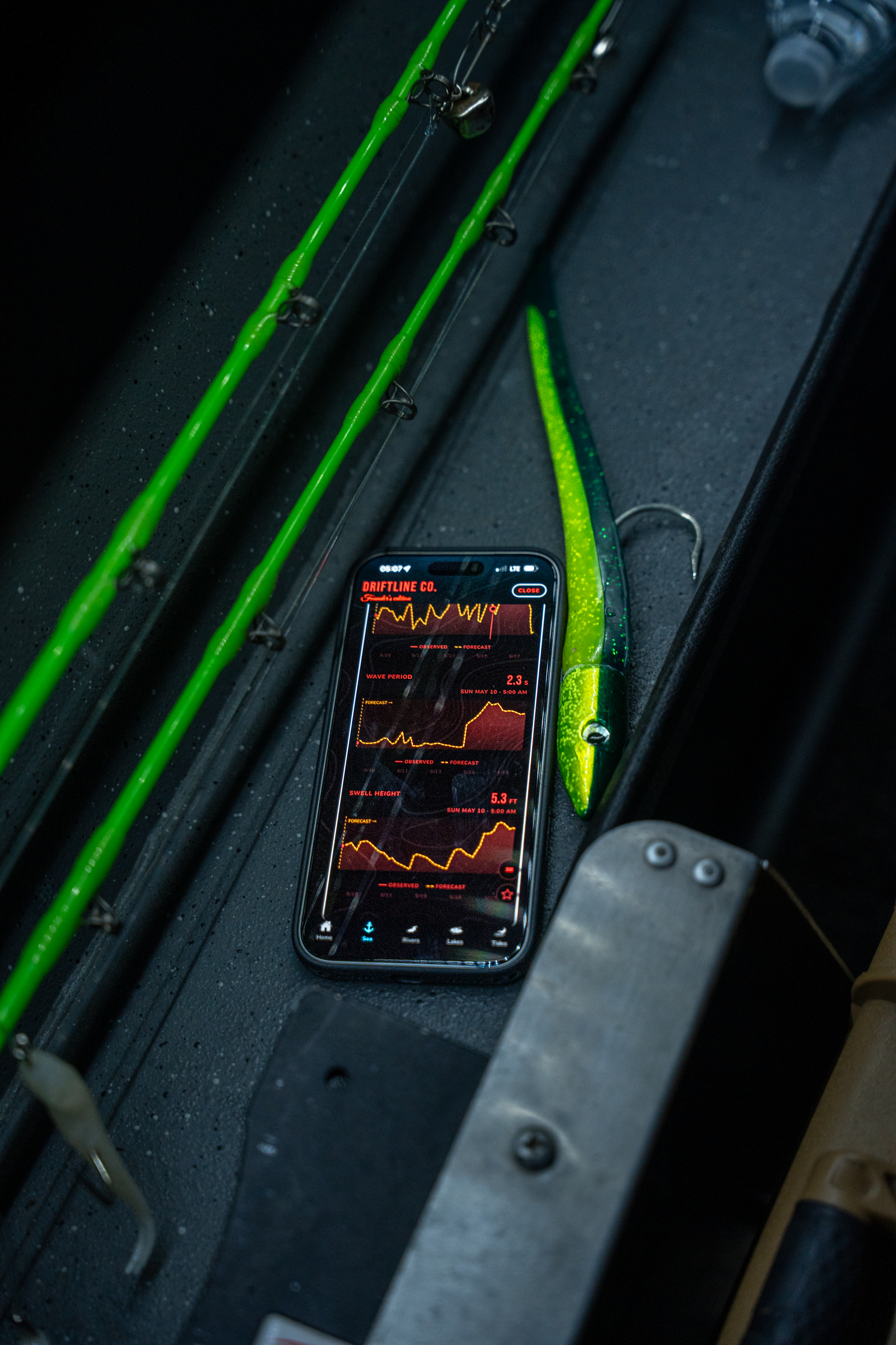 Baseline Maps Driftline mode on a phone next to fishing rods
