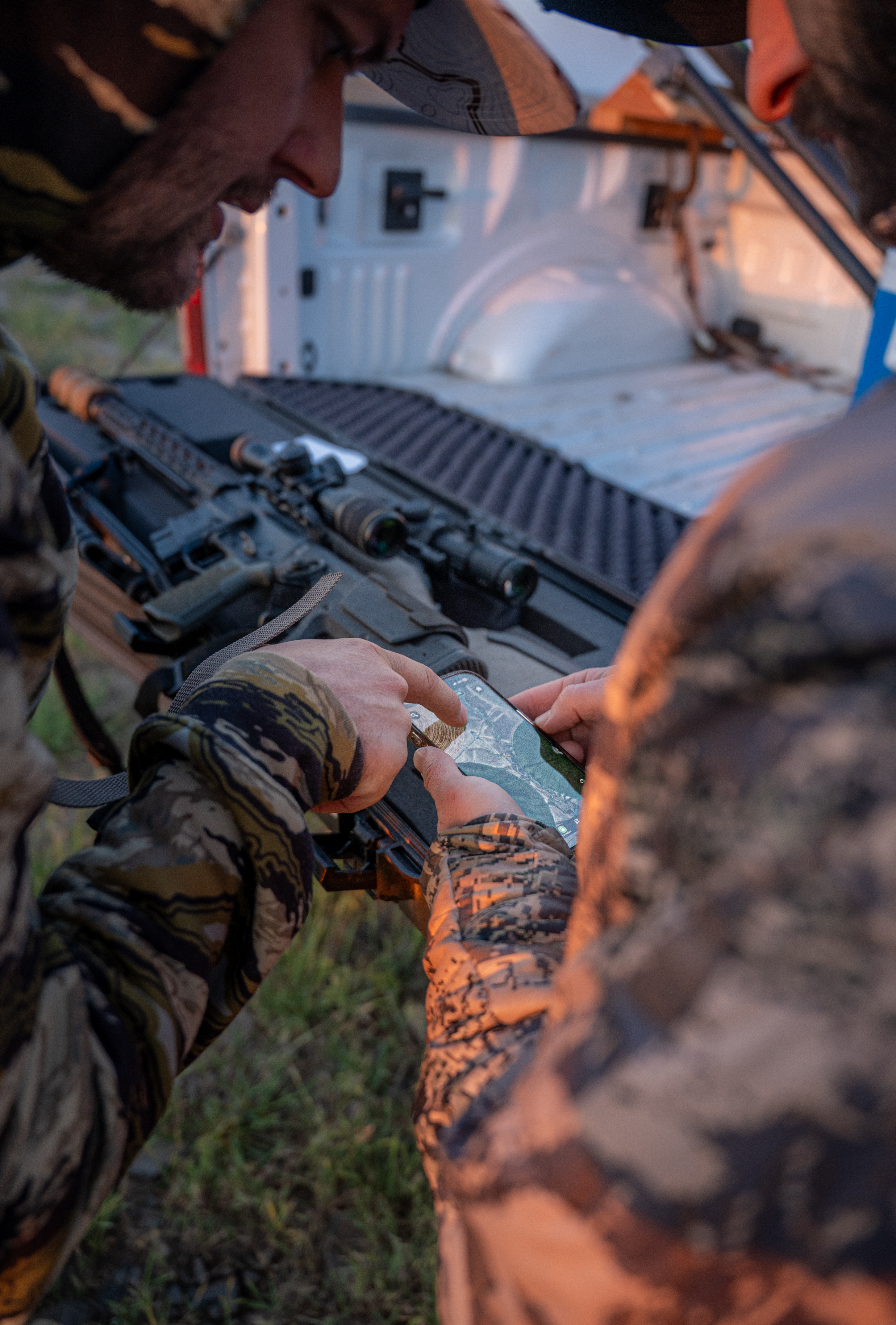 Two hunters checking Baseline Maps at the truck before opening day