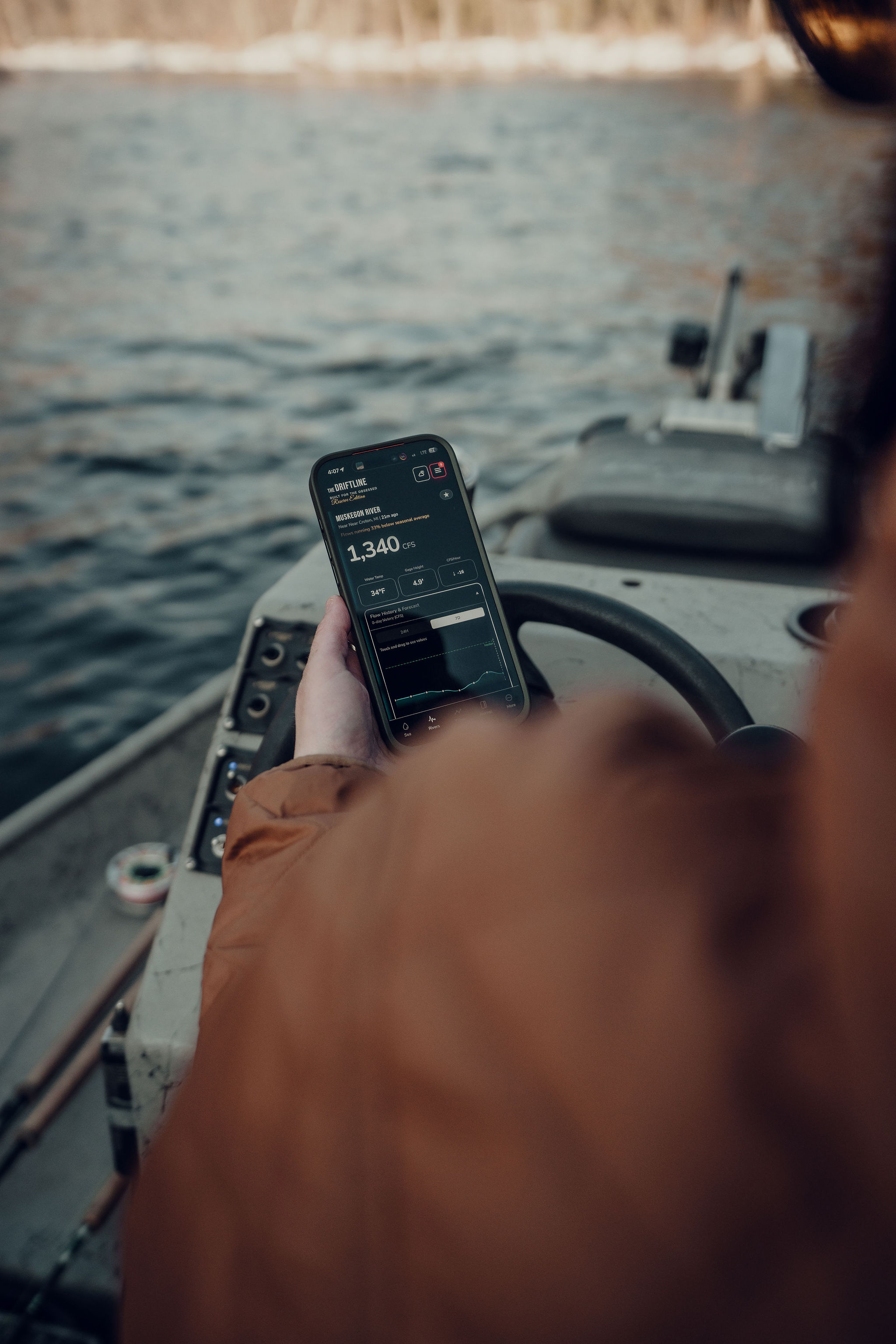 Angler checking Baseline Maps on a boat